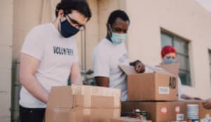 people at a stall wearing volunteer t-shirts