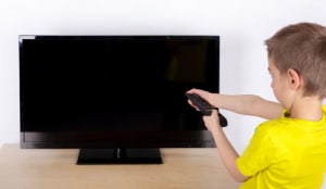 child turning off TV